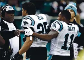  ?? MATT ROURKE — THE ASSOCIATED PRESS ?? Carolina Panthers wide receiver Torrey Smith holds back safety Eric Reid during an argument prior to a game against the Philadelph­ia Eagles during the 2018 season.