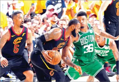  ?? AFP ?? Marcus Smart of the Boston Celtics defends the Cleveland Cavaliers’ LeBron James in Game 4 of the Eastern Conference Finals of the 2018 NBA Playoffs on Monday at Quicken Loans Arena in Cleveland, Ohio.