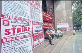  ??  ?? Bank Union members and employees sit outside the main gate of Reserve Bank of India during a nationwide strike called by various central trade unions in Kolkata on Thursday.