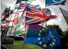  ?? AP ?? Flags, including a European flag, are blown by the wind after being placed there by Anti-Brexit remain in the European Union supporters near the Houses of Parliament in London.