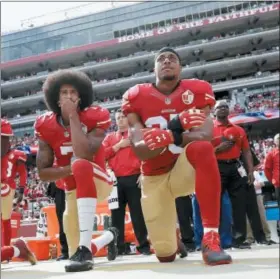  ?? MARCIO JOSE SANCHEZ — THE ASSOCIATED PRESS FILE ?? In this file photo, San Francisco 49ers quarterbac­k Colin Kaepernick, left, and safety Eric Reid kneel during the national anthem before an NFL football game against the Dallas Cowboys in Santa Clara As NFL training camps open, let’s not forget two...