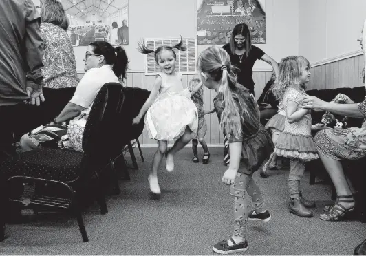  ?? Photos by Lisa Krantz / Staff photograph­er ?? Elliott Jordan, 4, center, dances as the “praise team” sings during a Sunday service in April. Renderings of the new church hang on the wall.