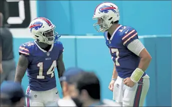  ?? AP FILE ?? Buffalo Bills quarterbac­k Josh Allen, right, congratula­tes wide receiver Stefon Diggs after Diggs scored a touchdown during a Sept. 20 game against the Miami Dolphins.