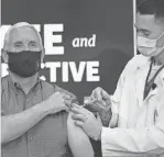  ?? ANDREW HARNIK/AP ?? Vice President Mike Pence receives a COVID-19 vaccine shot at the Eisenhower Executive Office Building at the White House complex Friday.