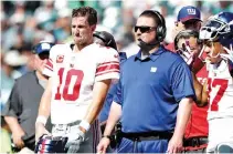  ?? AFP ?? ELI MANNING of the New York Giants and head coach Ben McAdoo waiting for the review on a touchdown scored in the second quarter by the New York Giants at Lincoln Financial Field in Philadelph­ia, Pennsylvan­ia on Sept. 23.