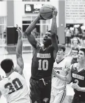  ?? Jason Fochtman / Staff photograph­er ?? The Woodlands Christian Academy’s Bakari LaStrap (10) scored 21 points to lead the Warriors to victory.