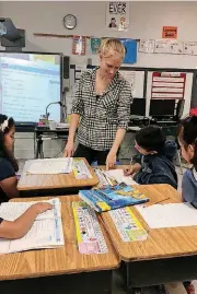  ?? PROVIDED]
[PHOTO ?? Westwood Elementary School teacher Abby Hernandez talks to her second-grade students about letters they have written to their counterpar­ts at a school in India.