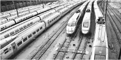  ??  ?? Photo shows trains stationed on tracks at a railway station. The leaders of Benin and Niger have given their backing to Chinese involvemen­t in a controvers­ial major rail infrastruc­ture project set to span several countries. — AFP photo