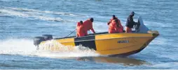  ??  ?? The five Richards Bay-based KZN Sharks Board employees servicing shark nets earlier this year Dave Savides