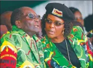  ?? AP file photo ?? Zimbabwean President Robert Mugabe (left) and his wife Grace — shown June 2 during a youth rally in Marondera, Zimbabwe — are reportedly being held under house arrest by the Zimbabwe military.