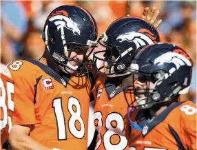  ?? David Zalubowski / Associated Press ?? Denver quarterbac­k Peyton Manning (18) celebrates a touchdown pass to Demaryius Thomas (88) during the first half of a win over the Cardinals.