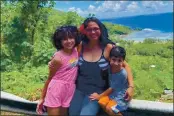  ?? EPIFANIA RAPOZO VIA AP ?? Epifania Rapozo, center, shows her with her two children Mila, left, and Levi, right, on hill side overlookin­g a scenic site on American Samoa’s main island of Tutuila. Rapozo, a native of American Samoa, and her children, from Washington state, have been stranded in American Samoa since Hawaiian Airlines flights were suspended late March. She and the children visited Pago Pago in February.