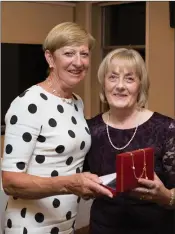  ??  ?? Hilary Flynn, a winner in the Lady President’s prize competitio­n, at Blainroe Golf Club receives her prize from Lady President Bernie Nelson.