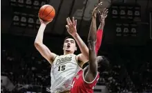  ?? Michael Conroy/Associated Press ?? Purdue center Zach Edey shoots over Ohio State center Felix Okpara in the second half in West Lafayette, Ind., on Sunday. Purdue defeated Ohio State 82-55.