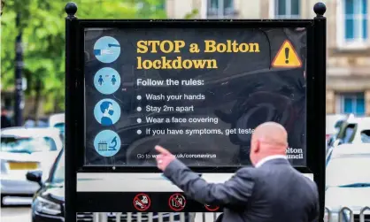  ?? Photograph: Peter Byrne/PA ?? Coronaviru­s signage in Bolton town centre. ‘The government appears content to hand responsibi­lity, should anything go wrong, to those who fail to “exercise their judgment” wisely.’