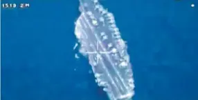  ??  ?? This image, made from video broadcast on Iranian State television Friday, shows drone footage of a U. S. aircraft carrier. Iranian State Television