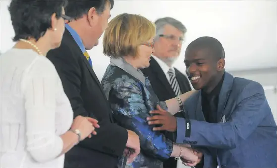  ?? Picture: COURTNEY AFRICA ?? CELEBRATIO­NS: Matriculan­t Lizo Ncapai, who achieved four distinctio­ns in last year’s exams, is congratula­ted by Penny Vinjevold, head of the Western Cape Education Department, Education MEC Donald Grant and Premier Helen Zille. Ncapai was a pupil at the Centre of Science and Technology in Khayelitsh­a which received a special ministeria­l award.