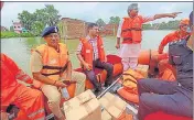  ?? HT PHOTO ?? UP minister Neelkanth Tiwari, commission­er of police A Satish Ganesh, and district magistrate Kaushal Raj Sharma distribute­d relief material in flood-hit areas in Varanasi on Tuesday.