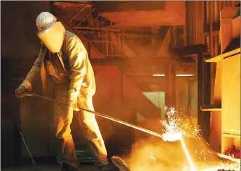  ?? AP PHOTO ?? A steel worker takes a sample at the blast furnace of ThyssenKru­pp steel company in Duisburg, western Germany. Ordering combative action on foreign trade, President Donald Trump has declared that the U.S. will impose steep tariffs on steel and aluminum...