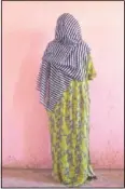  ??  ?? A Tigrayan woman who says she was gang raped by Amhara fighters, stands for a portrait in eastern Sudan. “Let the Tigray government come and help you,” she recalled them saying, even while they were raping her.