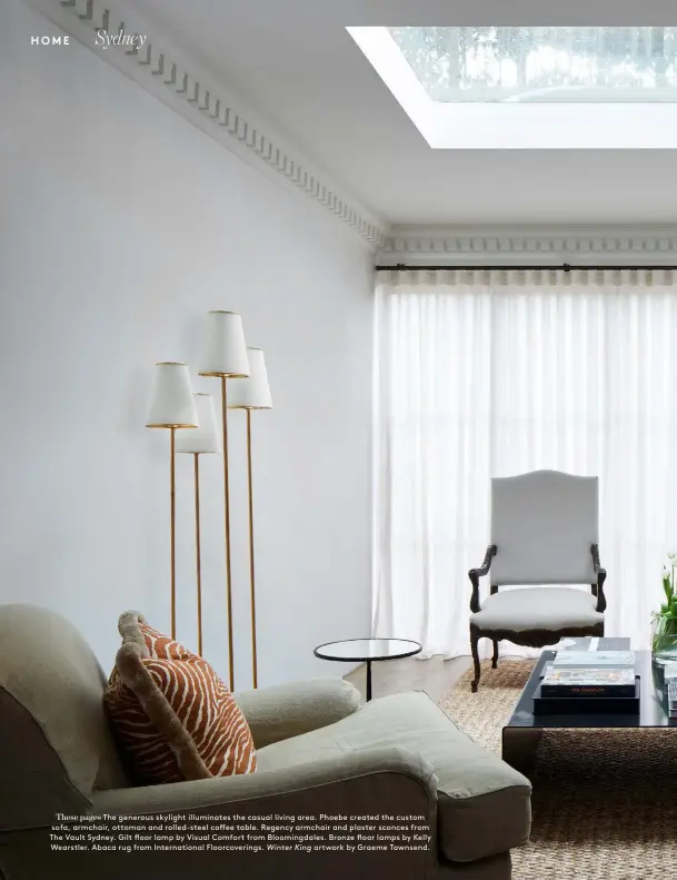  ??  ?? These pages The generous skylight illuminate­s the casual living area. Phoebe created the custom sofa, armchair, ottoman and rolled-steel coffee table. Regency armchair and plaster sconces from The Vault Sydney. Gilt floor lamp by Visual Comfort from Bloomingda­les. Bronze floor lamps by Kelly Wearstler. Abaca rug from Internatio­nal Floorcover­ings. Winter King artwork by Graeme Townsend.