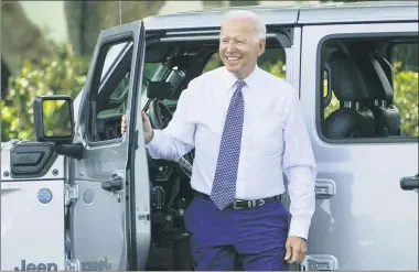  ?? SUSAN WALSH—SUSAN WALSH ?? President Joe Biden smiles after driving a Jeep Wrangler 4xe Rubicon on the South Lawn of the White House in Washington, Thursday, Aug. 5, 2021, during an event on clean cars and trucks.