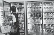  ?? [KOJI SASAHARA/ASSOCIATED PRESS FILE PHOTO] ?? Plastic-bottled soft drinks are displayed in fridges June 17, 2019, at a store in Yokohama, near Tokyo.