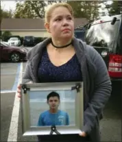  ?? FRANK ELTMAN—THE ASSOCIATED PRESS ?? In this photo taken Wednesday, Nov. 8, in Brentwood, N.Y., Maria Lezema holds a photograph of her nephew, Javier Castillo, 16, of Central Islip, N.Y. The FBI announced this week that Castillo’s body was positively identified after his remains were...