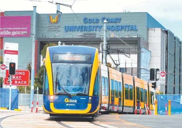  ??  ?? The G-Link light rail passes the Gold Coast University Hospital; (top, from left) arriving at Helensvale station; alongside the heavy rail track; and crossing Olsen Ave.