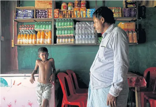  ??  ?? VULNERABLE: Azimul Hasan, 10, a Rohingya refugee boy, stands inside a roadside hotel where he works at Jamtoli, near Cox’s Bazar, Bangladesh.