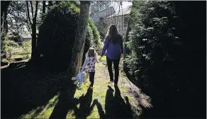  ?? MARK VAN MANEN/PNG ?? Alex Bevilacqua walks with her daughter through Forest Grove, a community not far from the scene of the latest unsolved sex assault in the North Burnaby-Burnaby Mountain area.