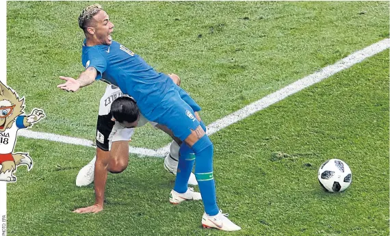  ??  ?? Neymar, right, of Brazil falls while vying with Costa Rica’s Giancarlo Gonzalez in the penalty box.