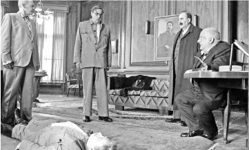  ?? — Courtesy of IFC Film/Reuters photo ?? Gathered around the body of Stalin (played by Adrian McLoughlin) are, from left, Steve Buscemi as Nikita Khrushchev, Jeffrey Tambor as Georgy Malenkov, Dermot Crowley as Lazar Kaganovich and Simon Russell Beale as Lavrenti Beria in Iannucci’s ‘The...