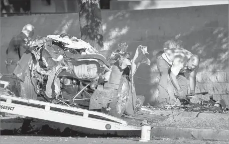  ?? Photograph­s by Irfan Khan Los Angeles Times ?? TWO MEN and two women in a BMW died when the car struck a tree. The impact was so severe the vehicle’s engine was ejected.