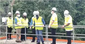  ?? — Photo by Ukas ?? Dr Rundi (third right) and others seen at the Nyabau water treatment plant.