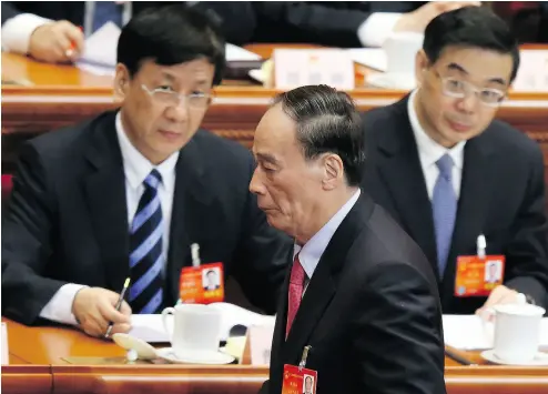  ?? FENG LI / GETTY IMAGES FILES ?? China’s Politburo Standing Committee member Wang Qishan, centre, at the opening session of the National People’s Congress in 2014. There is speculatio­n over his future on the committee when the new Poliburo is unveiled on Oct. 18.