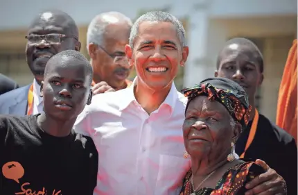  ?? DAI KUROKAWA/EPA-EFE ?? Former President Barack Obama poses with his step-grandmothe­r Sarah Obama, right, and a student during an opening ceremony for the Sauti Kuu Sports, Vocational and Training Centre in Kogelo, Kenya, in July 2018.