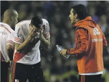  ?? AP ?? River Plate player Ramiro Funes Mori washes his face after the team was pepper sprayed by Boca Juniors fans in 2015