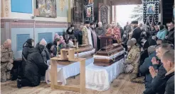  ?? BERNAT ARMANGUE/AP ?? Villagers attend the funeral of Ukrainian fighters Roman Rak and Mykola Mykytiuk on Wednesday.