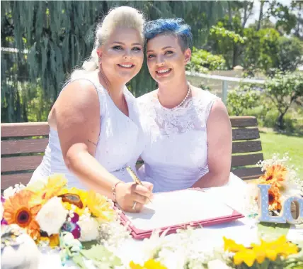  ?? CAROLINE McCREDIE ?? Lauren Price, right, and Amy Laker are the first gay couple to be legally married in Australia