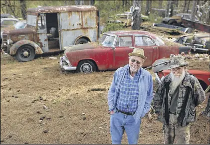  ?? CURTIS COMPTON / CCOMPTON@AJC.COM ?? Owner Walter Dean Lewis (left) and his friend Eddie McDaniel are ready to greet visitors entering Old Car City USA, 34 acres of part junkyard and part classic car museum of rust and roots showcasing over 4,000 vintage cars.