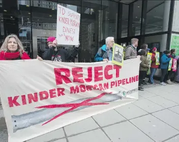  ?? JONATHAN HAYWARD/THE CANADIAN PRESS ?? Shares of Kinder Morgan, a target of anti-pipeline activists, had a rough ride Tuesday as they began trading on the TSX. Investors were deterred by political uncertaint­y in B.C. as well as the company’s plan to use IPO proceeds to pay down its U.S. debt.