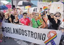  ?? JOHN RAOUX/ASSOCIATED PRESS ?? Hundreds show support and solidarity near the funeral service for Christophe­r Andrew Leinonen, one of the Orlando, Fla., nightclub shooting victims, on Saturday.