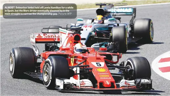  ?? Picture: AFP ?? ALMOST. Sebastian Vettel held off Lewis Hamilton for a while in Spain, but the Merc driver eventually steamed by in the main straight to narrow the championsh­ip gap.