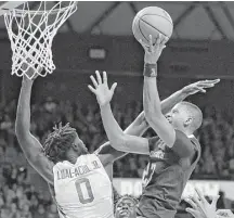  ?? Tony Gutierrez / Associated Press ?? Baylor center Jo Lual-Acuil Jr. (0) tries to get a hand in the face of Texas Tech guard Jarrett Culver in the first half,