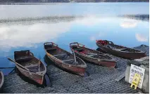  ??  ?? Traditiona­l gondola-style wooden row boats ply the waters of Lake Bled in Slovenia. No gas-powered boats here.