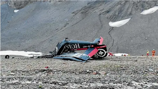  ?? AP ?? The wreckage of the propeller-driven plane Ju 52 lies on the Piz Segnas mountainsi­de above the Swiss Alpine resort of Flims.