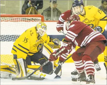  ?? John Vanacore / For Hearst Connecticu­t Media ?? Quinnipiac goaltender Andrew Shortridge makes a stop against UMass forward George Mika on Friday night in Hamden.