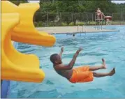  ??  ?? Damarion Tucker, 10, slides into the municipal pool in Knickerboc­ker Park in this photo from 2015.