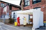  ?? ELIZABETHF­RANTZ/ NEWYORK TIMES ?? Ahealth care worker assists a patient Saturday at a coronaviru­s testing site in Providence, R. I. The rate of new cases in theU. S. is averaging 100,000a day.